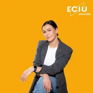 The image features a female that is dressed professionally in a yellow background.